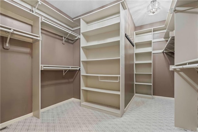 walk in closet featuring carpet flooring