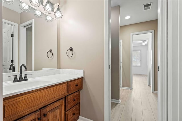 bathroom with hardwood / wood-style floors and vanity