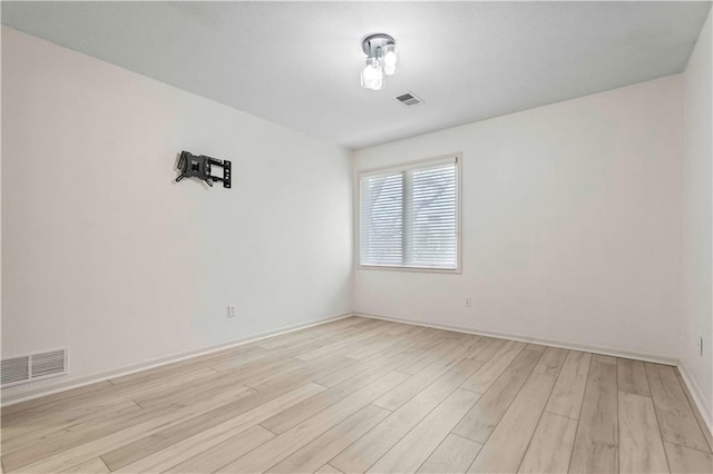 spare room featuring light wood-type flooring