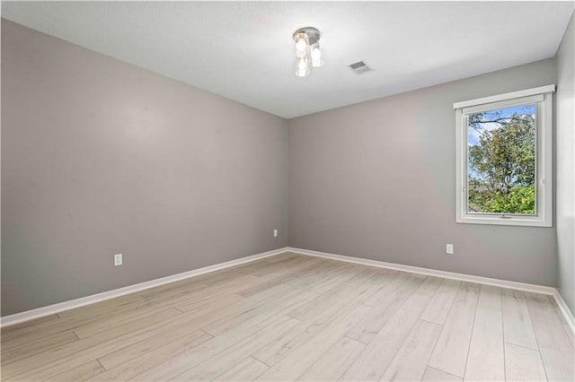 unfurnished room with light wood-type flooring