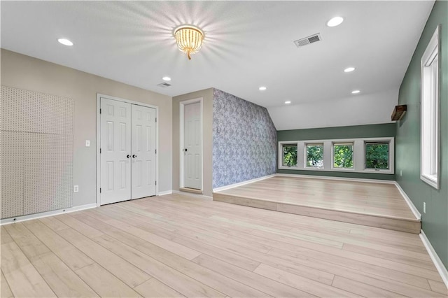 interior space featuring vaulted ceiling and light hardwood / wood-style flooring