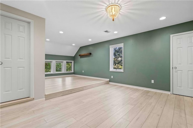 interior space featuring light hardwood / wood-style flooring and vaulted ceiling