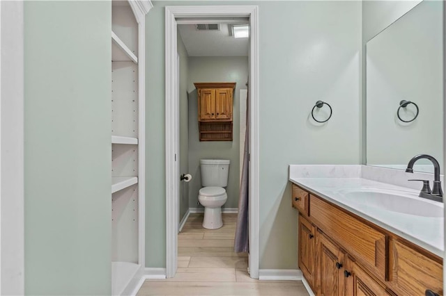 bathroom with curtained shower, vanity, toilet, and hardwood / wood-style flooring