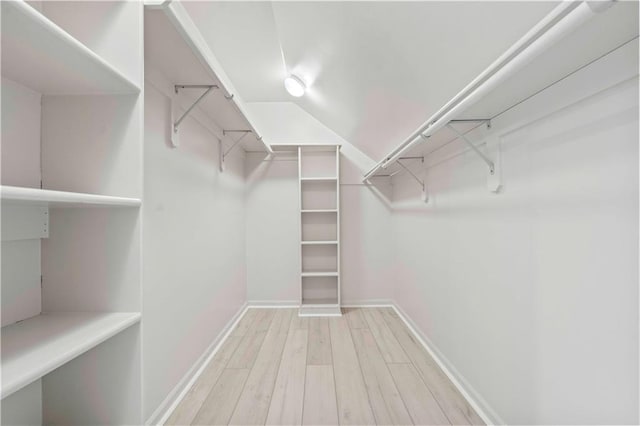 walk in closet with light wood-type flooring