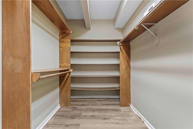 spacious closet featuring light hardwood / wood-style flooring