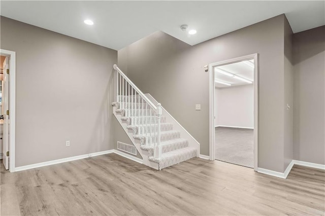 stairway with hardwood / wood-style floors