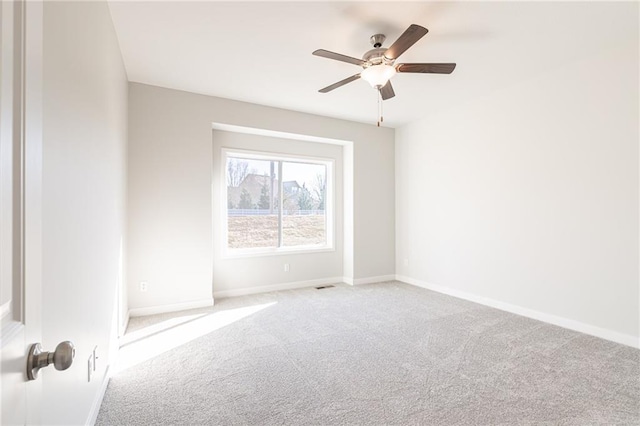 spare room featuring ceiling fan and light colored carpet