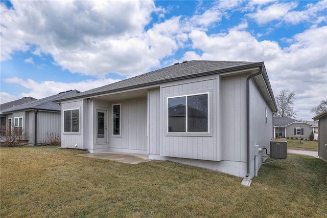 rear view of house with a lawn, a patio, and central air condition unit