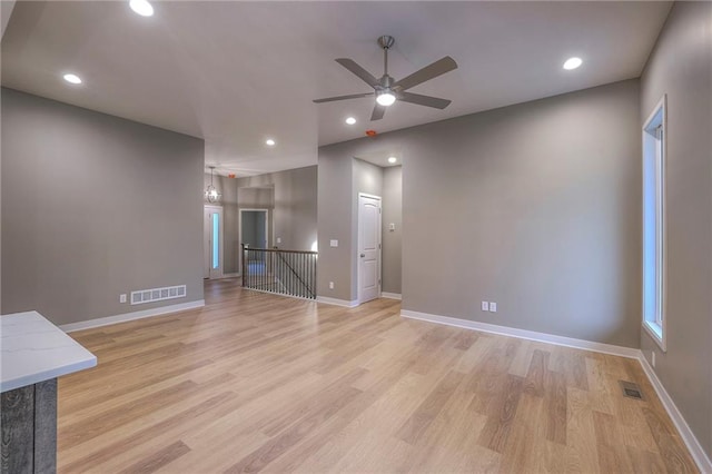 unfurnished living room with ceiling fan and light wood-type flooring