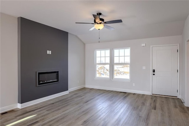 unfurnished living room with ceiling fan, light hardwood / wood-style flooring, and lofted ceiling