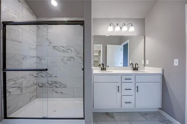 bathroom with vanity and a shower with shower door