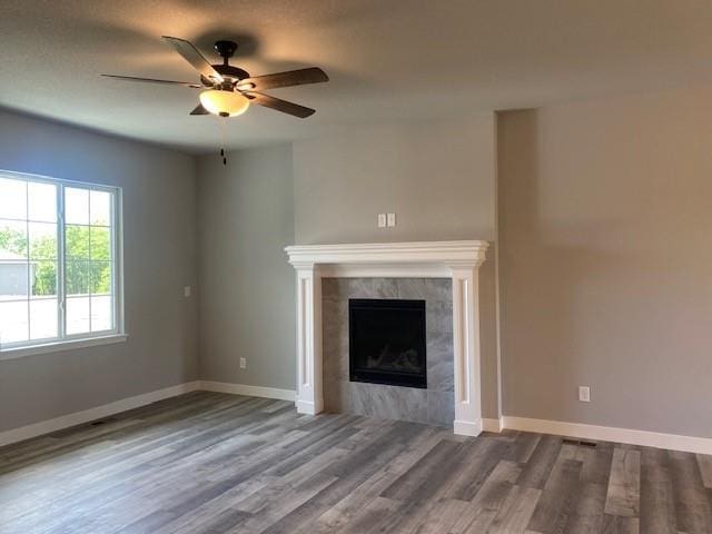 20870 W 190th Ter, Spring Hill, KS 66083 - unfurnished living room featuring ceiling fan, wood finished floors, and a tile fireplace