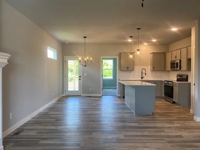 20870 W 190th Ter, Spring Hill, KS 66083 - kitchen with stainless steel appliances, plenty of natural light, dark wood-style floors, gray cabinetry, and recessed lighting