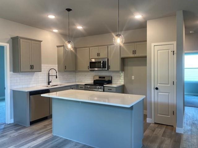 20870 W 190th Ter, Spring Hill, KS 66083 - kitchen with appliances with stainless steel finishes, gray cabinetry, wood finished floors, and a center island