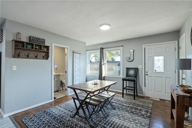 interior space with a textured ceiling and dark hardwood / wood-style flooring