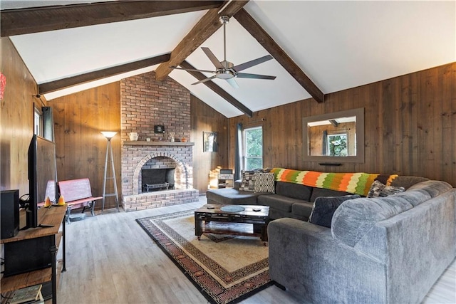 living room with a brick fireplace, vaulted ceiling with beams, hardwood / wood-style flooring, and wooden walls