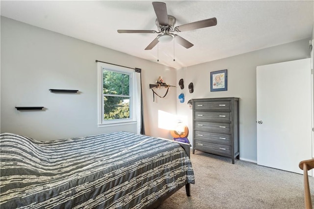 bedroom with ceiling fan and light colored carpet