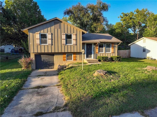 split level home with a garage and a front lawn