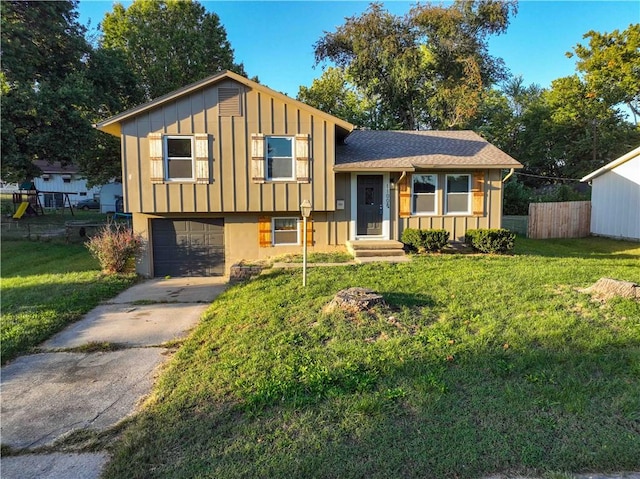 split level home with a garage and a front lawn