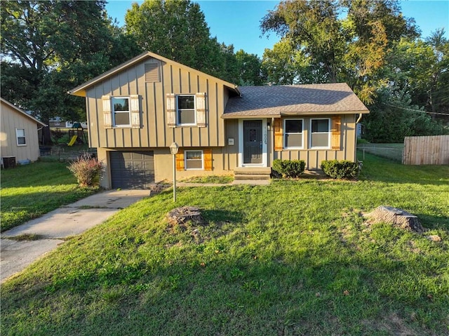 split level home with a front yard and a garage