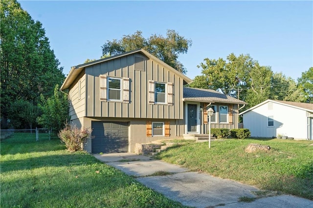 tri-level home with a garage and a front lawn