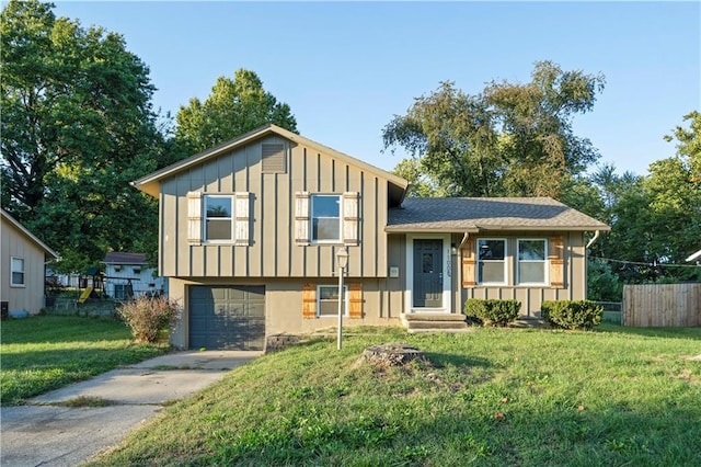 split level home with a front yard and a garage