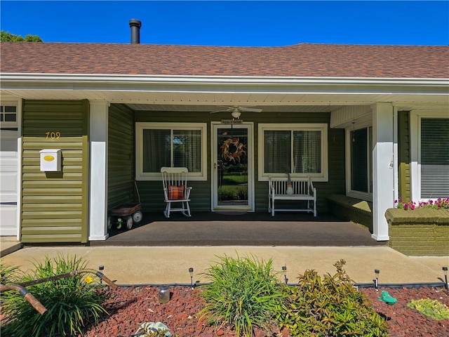 doorway to property featuring covered porch and ceiling fan