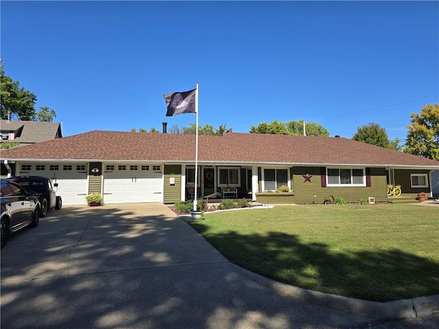 ranch-style house featuring a front lawn and a garage