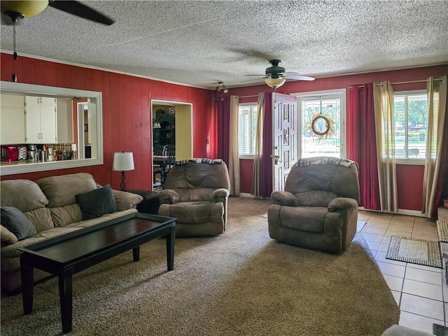 tiled living room featuring a textured ceiling and ceiling fan