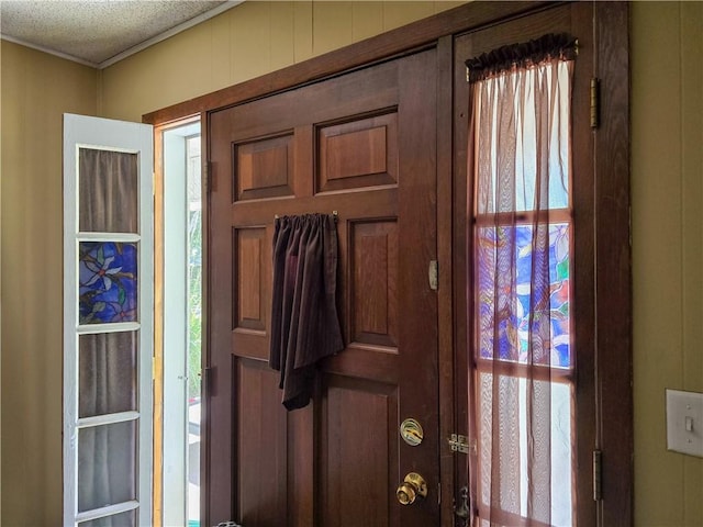 foyer entrance with a textured ceiling