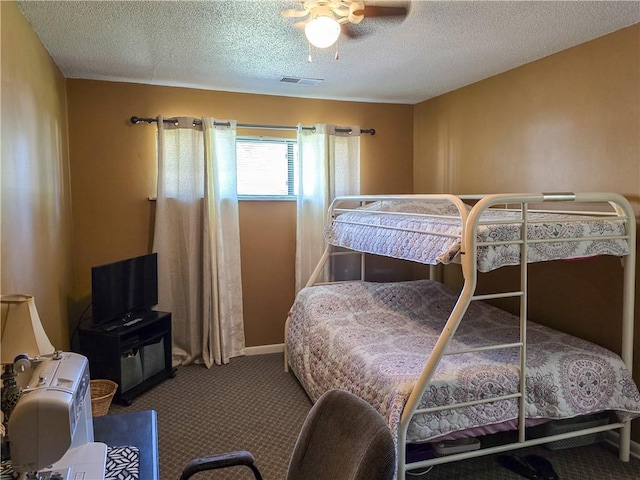 carpeted bedroom with a textured ceiling and ceiling fan