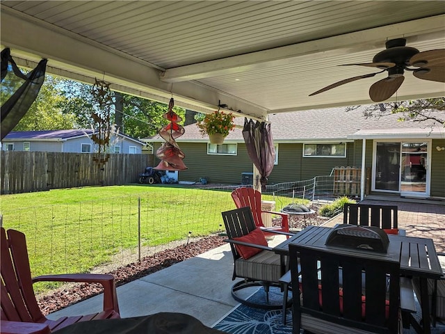 view of patio with ceiling fan and an outdoor fire pit