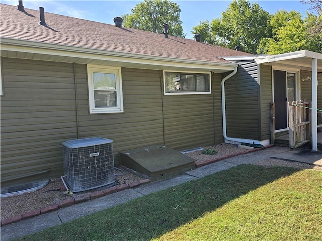 exterior space featuring a yard and central air condition unit