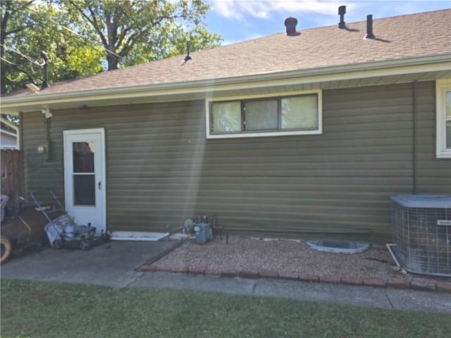 rear view of property featuring central air condition unit