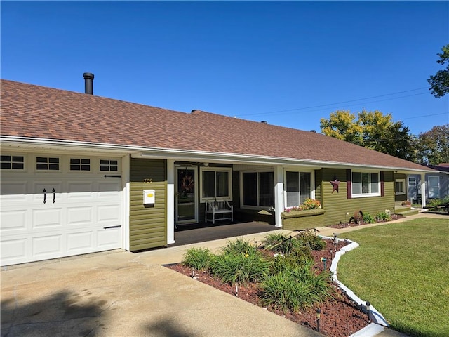 ranch-style home with a front lawn and a garage