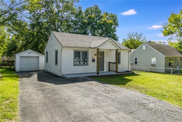 bungalow-style house with a front lawn, an outbuilding, and a garage