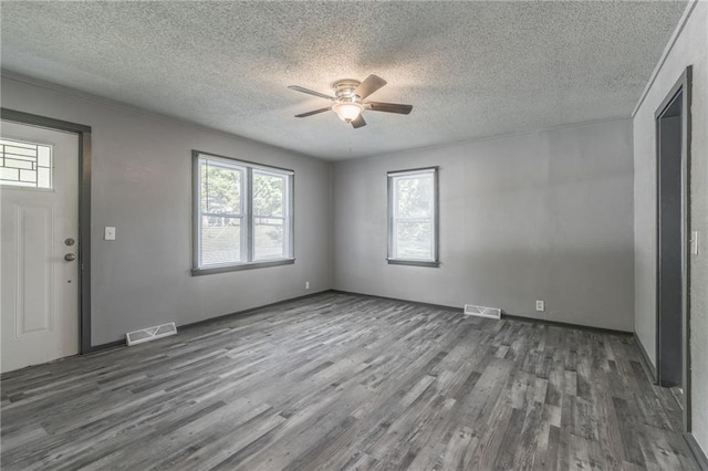 interior space featuring a textured ceiling, ceiling fan, and dark hardwood / wood-style floors