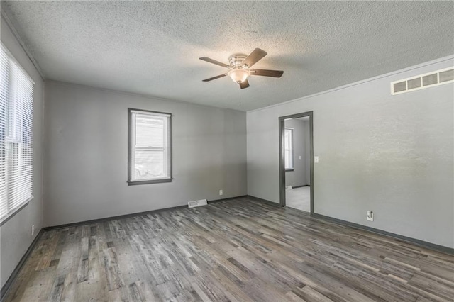 unfurnished room featuring ceiling fan, a textured ceiling, and wood-type flooring