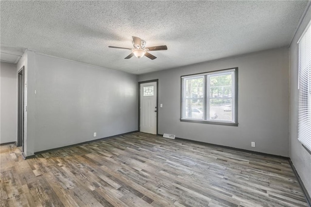 unfurnished room featuring ceiling fan, a textured ceiling, and hardwood / wood-style floors