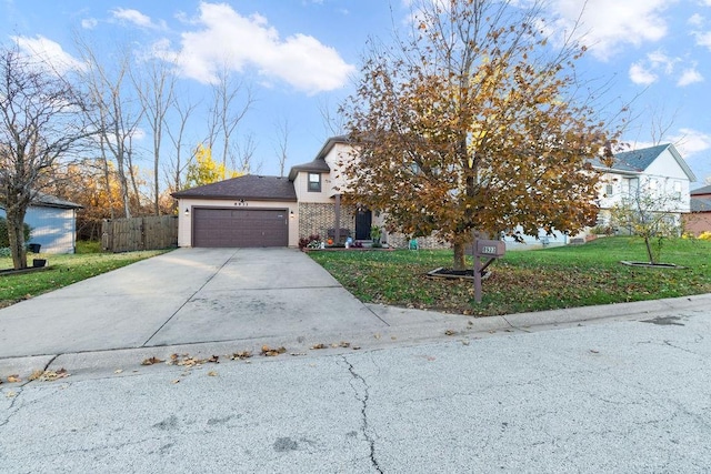 obstructed view of property with a front yard and a garage