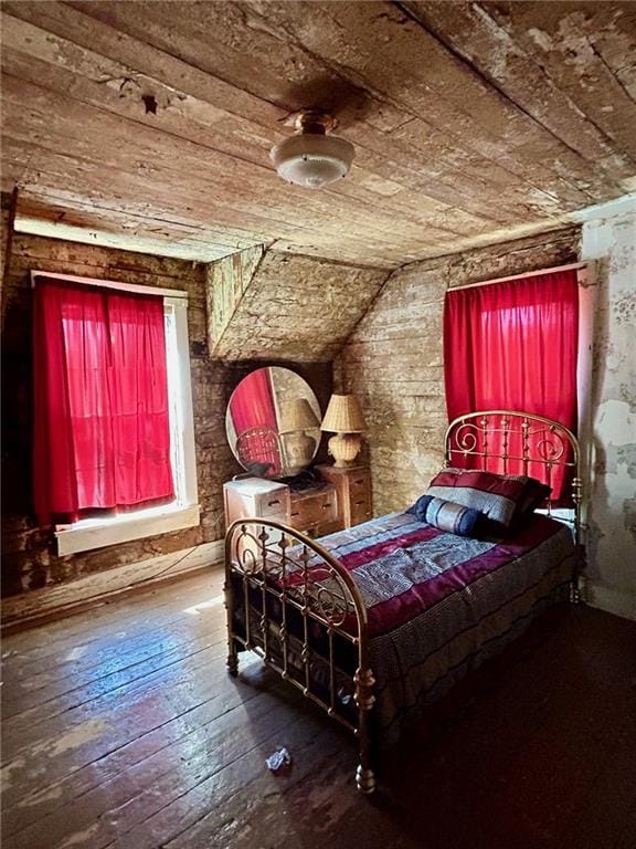 bedroom featuring hardwood / wood-style floors and vaulted ceiling