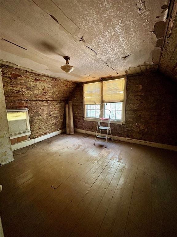 bonus room featuring vaulted ceiling and hardwood / wood-style floors