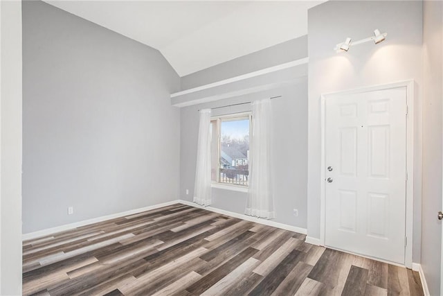 foyer entrance featuring dark hardwood / wood-style flooring and lofted ceiling