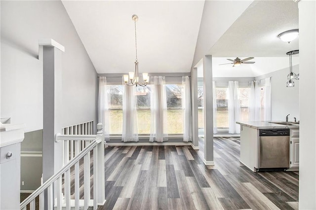 unfurnished dining area with ceiling fan with notable chandelier, dark hardwood / wood-style floors, lofted ceiling, and sink