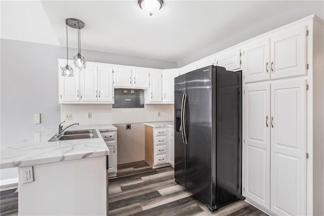 kitchen featuring kitchen peninsula, sink, pendant lighting, fridge with ice dispenser, and white cabinets