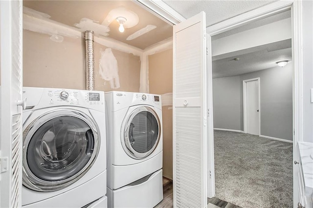 clothes washing area with washer and clothes dryer and carpet floors