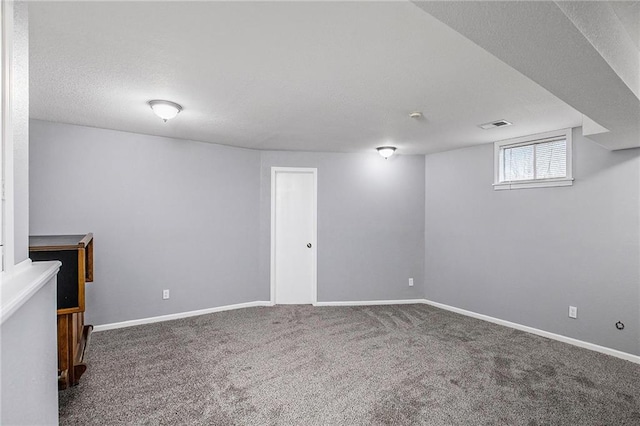 basement with carpet and a textured ceiling