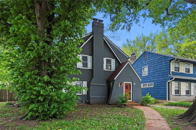 507 E 75th St, Kansas City, MO 64131 - view of front of property with brick siding, fence, and a chimney