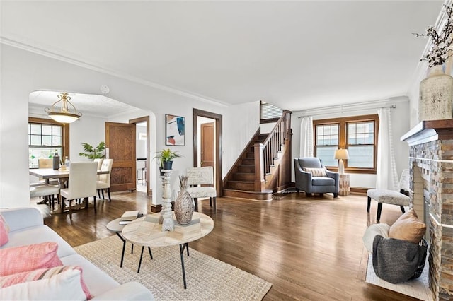 507 E 75th St, Kansas City, MO 64131 - living area featuring a wealth of natural light, wood finished floors, ornamental molding, and arched walkways