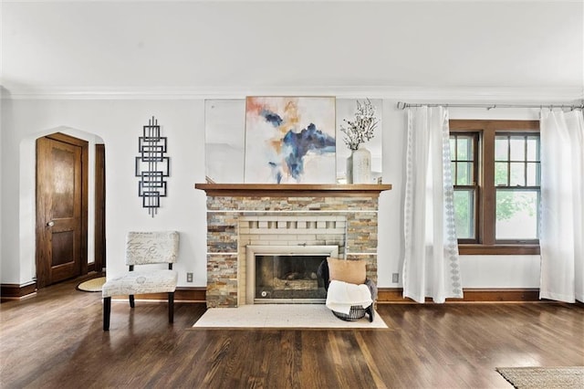 507 E 75th St, Kansas City, MO 64131 - sitting room featuring baseboards, wood finished floors, arched walkways, and crown molding